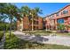 Exterior walkway and patio with multi-story townhouse and tropical landscaping at 2717 Via Cipriani # 623B, Clearwater, FL 33764