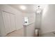 Bright hallway featuring white walls, a chandelier, and a view of the staircase at 2717 Via Cipriani # 623B, Clearwater, FL 33764