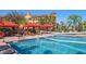 Exterior community pool with lounge chairs, cabanas, and a volleyball net at 2717 Via Cipriani # 623B, Clearwater, FL 33764