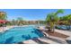 Community pool area with palm trees, sun loungers and cabanas offering a resort-like experience at 2717 Via Cipriani # 623B, Clearwater, FL 33764