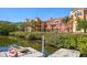 Waterfront view of the community building with a dock and boat, a picturesque setting at 2717 Via Cipriani # 623B, Clearwater, FL 33764