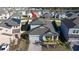 Aerial view of a light blue house, showcasing its roof, driveway, and landscaping in a neighborhood setting at 3042 Marine Grass Dr, Wimauma, FL 33598