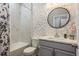 Modern bathroom features a vanity, decorative mirror, and tub with tiled walls at 3042 Marine Grass Dr, Wimauma, FL 33598