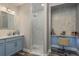 Modern bathroom features white marble shower, single vanity, and makeup station at 3042 Marine Grass Dr, Wimauma, FL 33598