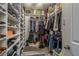 Spacious walk-in closet with custom shelving for optimal storage and organization at 3042 Marine Grass Dr, Wimauma, FL 33598