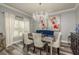 Formal dining room with a crystal chandelier, elegant furniture and luxury vinyl floors at 3042 Marine Grass Dr, Wimauma, FL 33598