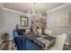 Elegant dining room with statement chandelier, luxury vinyl flooring and decorative art at 3042 Marine Grass Dr, Wimauma, FL 33598