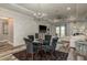 Elegant dining room with designer chandelier, tray ceiling, accent wall, and decor at 3042 Marine Grass Dr, Wimauma, FL 33598