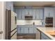 Modern kitchen with stainless steel appliances, blue cabinets, and stone countertops at 3042 Marine Grass Dr, Wimauma, FL 33598