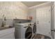 Functional laundry room equipped with appliances, sink, and storage at 3042 Marine Grass Dr, Wimauma, FL 33598