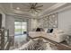 Open concept living room with hardwood flooring, neutral colors, tray ceilings and sliding doors to patio at 3042 Marine Grass Dr, Wimauma, FL 33598