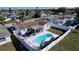 Aerial view of the fenced backyard with a pristine pool and cozy screened patio at 3142 Domino Dr, Holiday, FL 34691