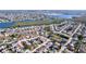 Bird's-eye view of a residential area dotted with houses, green spaces, and winding waterways at 3142 Domino Dr, Holiday, FL 34691