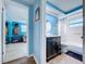 Powder blue bathroom with a modern vanity and a round mirror above the sink at 3142 Domino Dr, Holiday, FL 34691