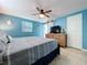 Bedroom featuring light blue walls, tile floors, and a dresser with TV at 3142 Domino Dr, Holiday, FL 34691