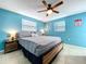 Comfortable bedroom showcasing tiled floor, bed with pillows, and bright blue walls at 3142 Domino Dr, Holiday, FL 34691