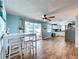 Dining area featuring access to a pool, ceiling fan, and kitchen with white cabinets at 3142 Domino Dr, Holiday, FL 34691