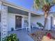 Inviting front porch featuring decorative posts, fresh landscaping, and outdoor seating area at 3142 Domino Dr, Holiday, FL 34691