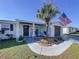 Inviting front porch featuring decorative posts, fresh landscaping, and outdoor seating area at 3142 Domino Dr, Holiday, FL 34691