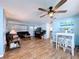 Bright and airy living room with wood-look tile, ceiling fan, and neutral wall paint at 3142 Domino Dr, Holiday, FL 34691