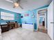 Living room featuring bright blue walls, tile floors, a sofa, and a modern cabinet at 3142 Domino Dr, Holiday, FL 34691