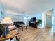 Bright and airy living room with wood-look tile, ceiling fan, and neutral wall paint at 3142 Domino Dr, Holiday, FL 34691