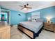 Spacious main bedroom featuring a ceiling fan, natural light, and neutral decor at 3142 Domino Dr, Holiday, FL 34691