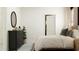 Bright main bedroom showcasing a black dresser, decorative mirror, and stylish rug at 32004 Spiceberry St, San Antonio, FL 33576