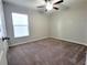 Neutral bedroom with carpet, fan, and a window that brings in natural light at 3406 Kearsney Abbey Cir, Dover, FL 33527