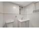 Bathroom featuring white walls, beadboard, a sleek vanity, and a large, bright mirror at 3544 Landale Dr, Holiday, FL 34691