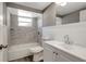 Bright bathroom with a tub/shower combo, white vanity, and large mirror at 3544 Landale Dr, Holiday, FL 34691