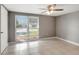 Bedroom with tiled floor, ceiling fan, and large window letting in lots of natural light at 3544 Landale Dr, Holiday, FL 34691