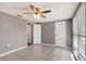 Bedroom featuring tile floors, neutral paint, a ceiling fan, and two closets at 3544 Landale Dr, Holiday, FL 34691