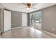 Bedroom with tiled floor, ceiling fan, and large window with a view to the outdoors at 3544 Landale Dr, Holiday, FL 34691