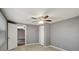 Bedroom with tiled floors, neutral paint, ceiling fan, and standard closet with sliding doors at 3544 Landale Dr, Holiday, FL 34691