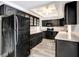 Well-lit kitchen featuring granite countertops, stainless steel appliances, and black cabinetry at 3544 Landale Dr, Holiday, FL 34691