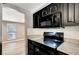 Kitchen with stainless steel appliances, stone countertops, and view to living room at 3544 Landale Dr, Holiday, FL 34691