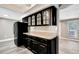 Kitchen with black cabinets, stone countertops, view into living room at 3544 Landale Dr, Holiday, FL 34691