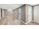 Bright living room with neutral walls, light-colored flooring, and a view of the entrance and front windows at 3544 Landale Dr, Holiday, FL 34691