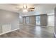 Open-concept living room with light-colored flooring, neutral walls, ceiling fan, and ample natural light at 3544 Landale Dr, Holiday, FL 34691