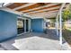 Inviting patio area with sliding glass doors, extending the living space outdoors for relaxation and enjoyment at 3544 Landale Dr, Holiday, FL 34691