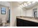 Bathroom featuring a granite countertop with double sinks and decorative light fixture at 3568 Pine Ribbon Dr, Land O Lakes, FL 34638