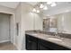 Bathroom featuring double vanity with granite countertops, decorative lights, and a glass door shower at 3568 Pine Ribbon Dr, Land O Lakes, FL 34638