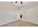 Bedroom featuring neutral walls, carpet, ceiling fan, closet and an open doorway to an adjacent room at 3568 Pine Ribbon Dr, Land O Lakes, FL 34638