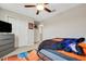 Well-lit bedroom with basketball-themed decor, carpet flooring, and a spacious closet at 3568 Pine Ribbon Dr, Land O Lakes, FL 34638