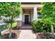 Exterior view of home featuring manicured landscaping, brick pathway to covered entry and front door at 3568 Pine Ribbon Dr, Land O Lakes, FL 34638