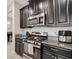 Close up of kitchen with stainless steel appliances and dark wood cabinetry at 3568 Pine Ribbon Dr, Land O Lakes, FL 34638