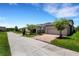 View of home exteriors showcasing well-maintained lawns, landscaping, and brick paver driveways at 3568 Pine Ribbon Dr, Land O Lakes, FL 34638