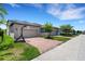 Street view showing home with two-car garage, brick paver driveway and basketball hoop at 3568 Pine Ribbon Dr, Land O Lakes, FL 34638