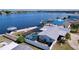 Aerial view of screened pool, boat dock, and waterfront backyard at 4941 Waterside Dr, Port Richey, FL 34668